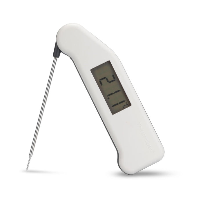 White digital thermometer with a screen displaying temperature on a white background